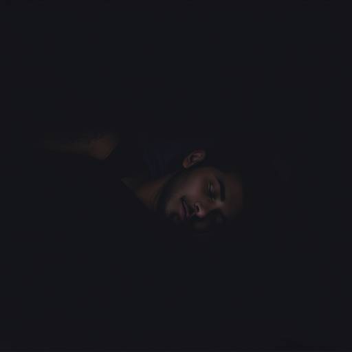 A person sleeping peacefully in a dark room